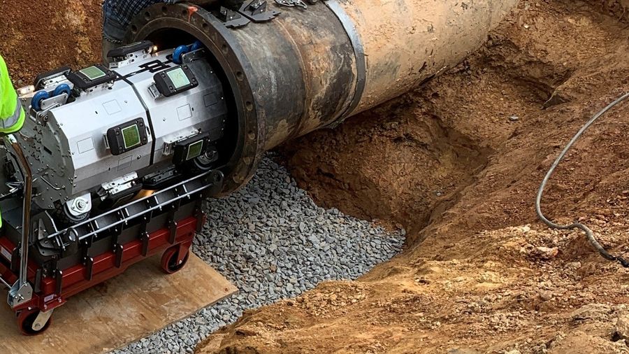 In-line cleaning and inspection tool entering a pipeline during a field trial